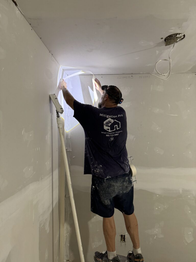 Drywall repair contractor patching ceiling drywall in Morgan City Louisiana